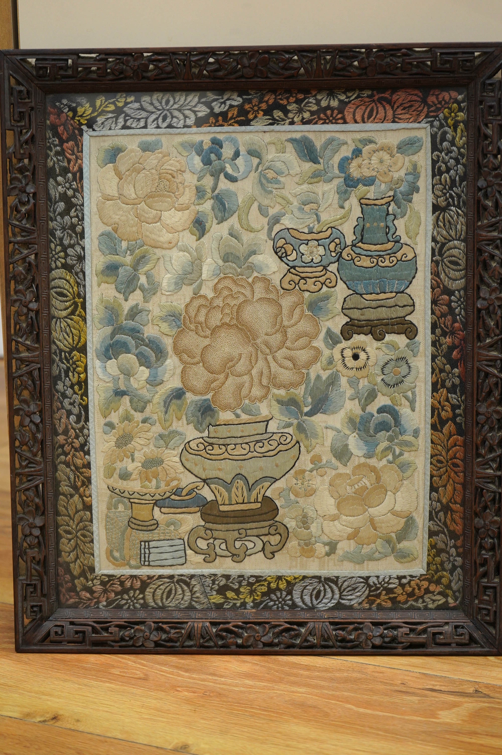 Two 19th century Chinese silk embroideries, one of a Chinese a musician on horseback and a boy behind carrying a banner, the other a Chinese knot floral embroidery of vases of flowers with brocade border, both embroideri